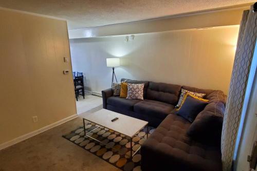 a living room with a couch and a table at Suite 7, Sleep 6, Walk to Attractions in Uptown in Charlotte