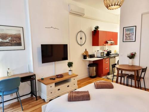 - un salon avec 2 lits et une télévision dans l'établissement The Republik - Studio Haussmannien près du panier, à Marseille