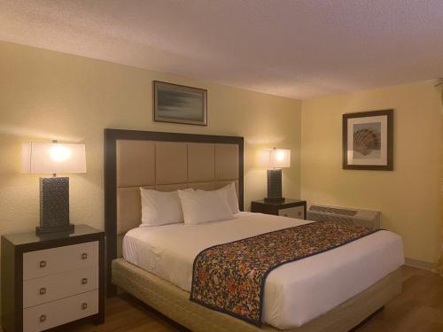 Un pat sau paturi într-o cameră la OK Hotel