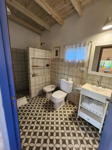 a bathroom with a toilet and a sink at La Pelereca in Las Gaviotas