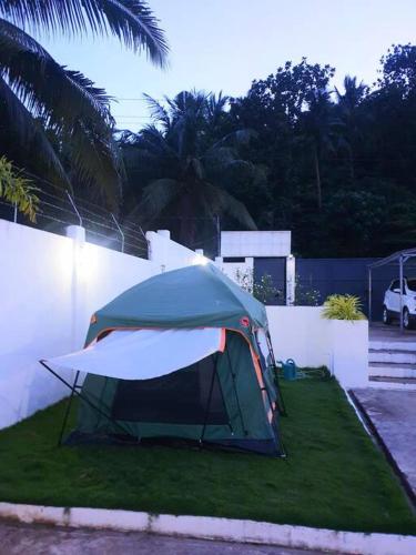 een tent op het gras in een tuin bij Charming 3 bedroom Events Place with private pool in Romblon