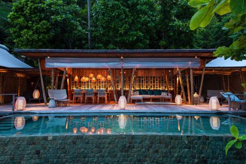 a resort with a swimming pool and a bar at Bawah Reserve in Mampo