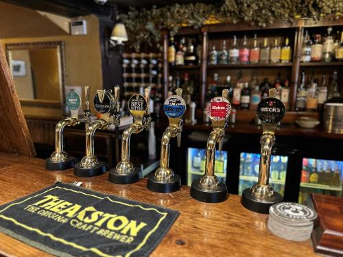 a row of trophies sitting on a bar at The George Hotel Easingwold in Easingwold