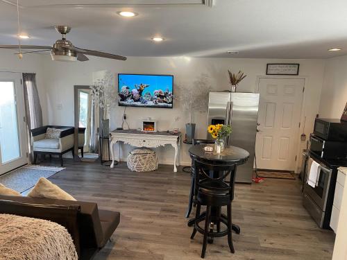 a living room with a refrigerator and a table at Serenity home in Laplace