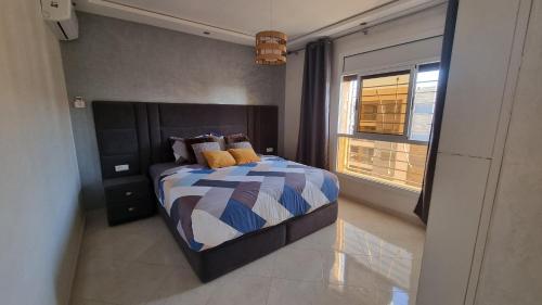een slaapkamer met een bed en een raam bij Nador Khattabi 2-19 in Nador