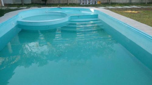 a large pool of blue water in a yard at Yatzil in La Trinitaria