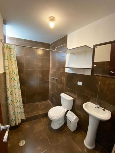 a bathroom with a toilet and a sink at Lonko Hostel Arequipa in Arequipa