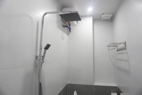 a bathroom with a shower with a light on the wall at Adal Motel in Kiến An