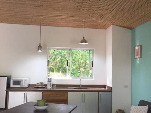 a kitchen with a sink and a window at Cote Pacific Casitas in Huacas