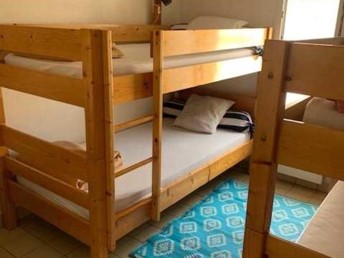 two wooden bunk beds in a room at Maison Individuelle Agréable, Animaux Admis, Proche Plage - FR-1-476-81 in La Faute-sur-Mer
