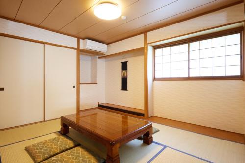 a room with a table and a large window at Reyzenit Kinosaki Suite VILLA in Toyooka