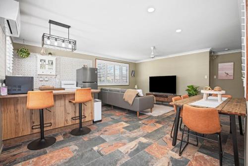 a living room with a couch and a table at Akuli By The Sea Unit 4 in Iluka