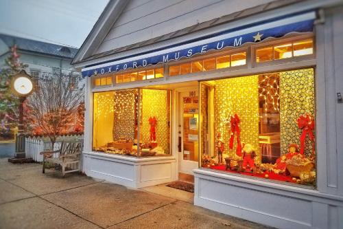 a store front with christmas lights in the window at Sandaway Suites & Beach in Oxford