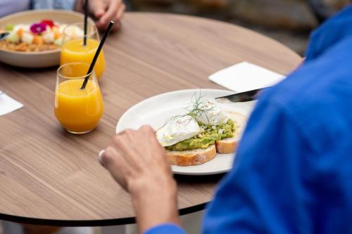 a person sitting at a table with a plate of food at Mercure Kangaroo Island Lodge in American River