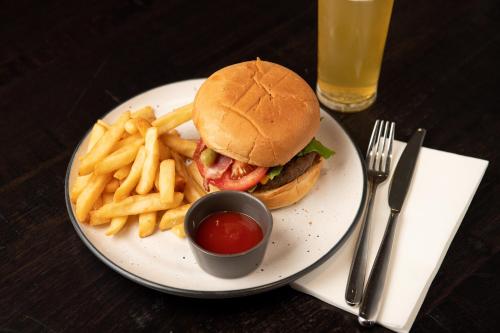 a plate with a sandwich and french fries and ketchup at Mercure Kangaroo Island Lodge in American River