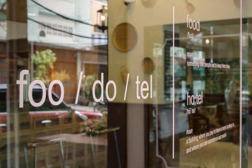 a glass door with the words too i do i felt at FOODOTEL in Bangkok