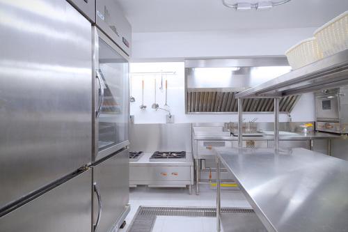 a kitchen with a stainless steel refrigerator and stove at FOODOTEL in Bangkok