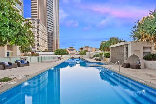 a large swimming pool with blue water in a building at Spectacular 19th Floor Apartment in Heart of Surfers Paradise in Gold Coast
