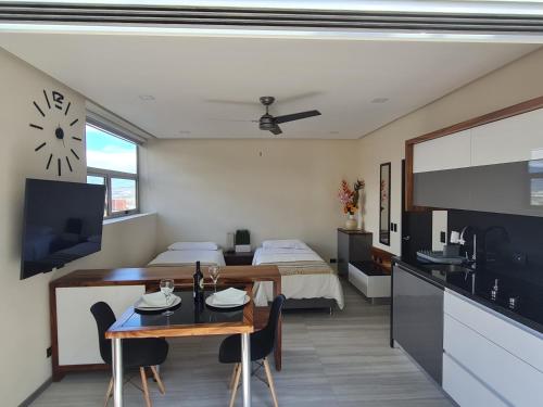 a kitchen and living room with a table and a bed at Cute Escazú Loft -Great view- in Escazu