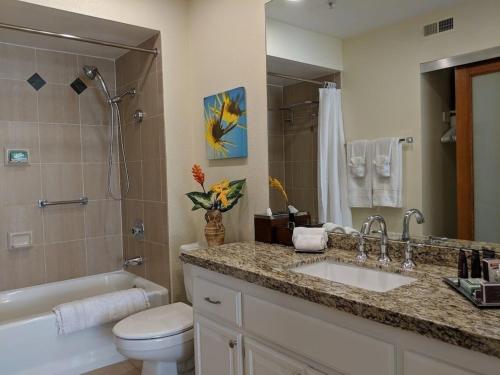 a bathroom with a sink and a toilet and a tub at Upscale 2Bed 2Bath Condo Prime Location WiFi Pools Kitchen Security in Palm Springs