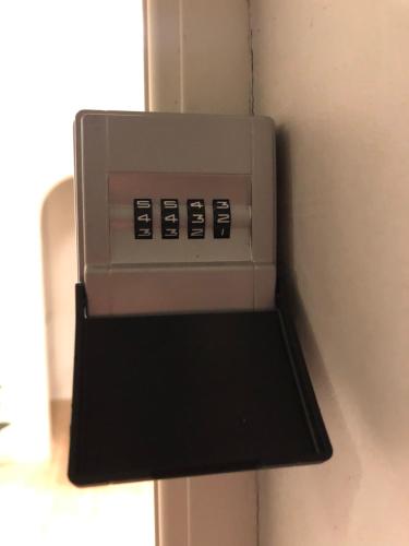 a machine with four buttons on the side of a wall at Lille Skovgaarden ved parken in Randers