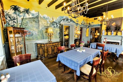 a dining room with tables and chairs and a mural at Casa De Solana Bed and Breakfast in St. Augustine