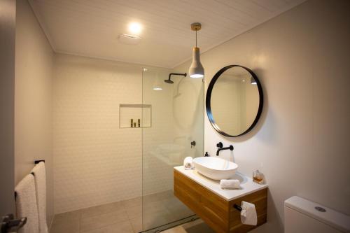 a bathroom with a sink and a shower with a mirror at Zambezi Lodge, Down South Luxe Retreat in Wilyabrup