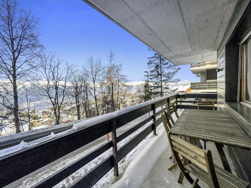 a balcony with a wooden bench on a house at Prachalier II - Next to Nendaz cable car - Swiss Alps in Nendaz