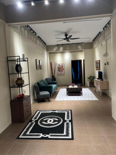 a living room with a couch and a table at Pillow Home Town City in Kuala Terengganu