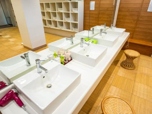 a row of sinks in a bathroom at Kurohime Kogen Hotel in Shinano