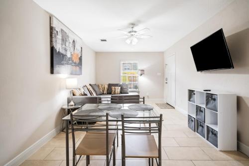 a living room with a table and chairs and a couch at Opulent, Luxurious & Modern APT 7 Min From TX Med Center in Houston