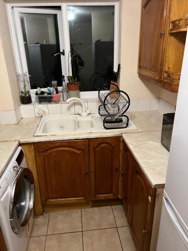 a kitchen with a sink and a washing machine at Henderson court in London