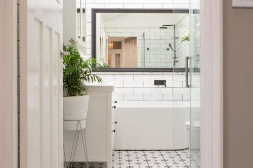 a bathroom with a sink and a toilet and a mirror at The East-Redfern Mansion on Chelsea in Sydney