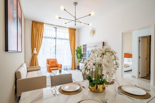 a living room with a dining table and a living room at Primestay - Prime Views Meydan 1BR in Dubai