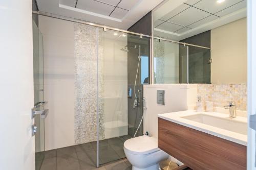 a bathroom with a shower and a toilet and a sink at Primestay - Prime Views Meydan 1BR in Dubai