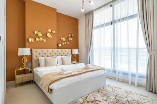 a bedroom with a large bed and a large window at Primestay - Prime Views 1BR in Al Meydan in Dubai