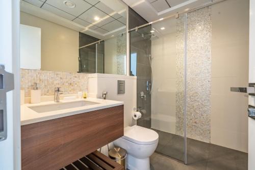 a bathroom with a sink and a toilet and a shower at Primestay - 1BR in Prime Views in Al Meydan in Dubai