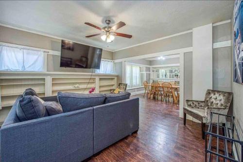 a living room with a blue couch and a ceiling fan at 2 King Beds! Fantastic Stylish Bungalow home! in Fresno