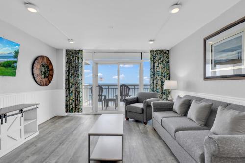 a living room with a couch and a table at Oceanfront Atlantica 2BR Condo w Balcony in Myrtle Beach
