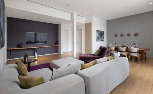 a living room with a couch and a tv at Cramim by Isrotel Exclusive in Qiryat ‘Anavim