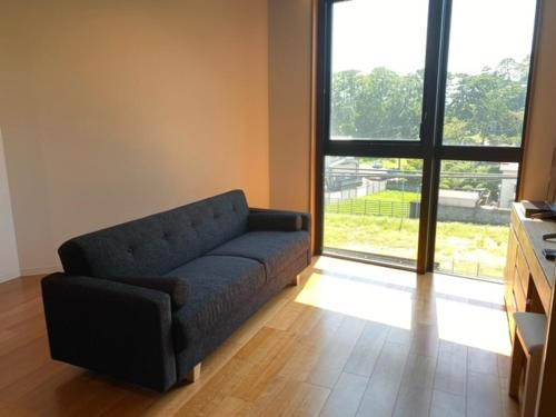 a living room with a couch and a large window at THE VIEW Odawara shiro-no mieru hotel - Vacation STAY 67008v in Odawara