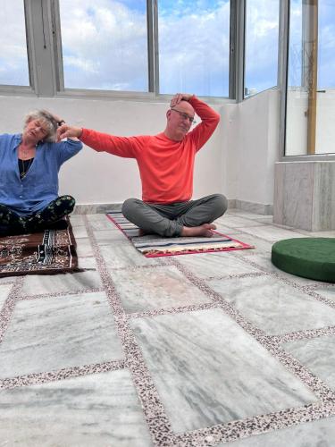 a man and a woman sitting on the floor at Krishnabalram wellness & Ayurveda centre in Rishīkesh