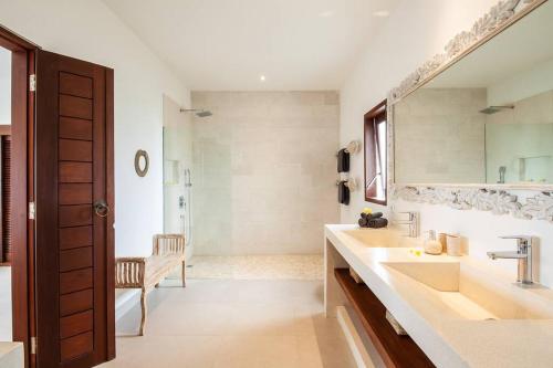 a bathroom with a sink and a mirror at Villa Matigo Canggu in Canggu