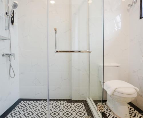 een badkamer met een toilet en een glazen douche bij SPRINGHILL RESORT in Cameron Highlands
