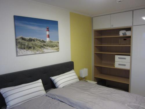 a bedroom with a bed and a light house at Hanseat II - Whg 183 "Meeresperle" in Grömitz