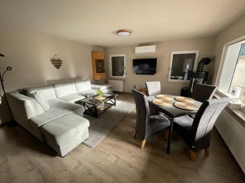 a living room with a couch and a table at Kiefernblick in Plötzky