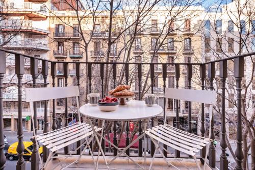 a table and two chairs on a balcony at Sweett - Carrer Bailen in Barcelona