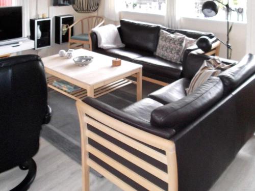 a living room with a couch and a table at 6 person holiday home in Henne in Henne Strand