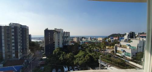a city view of a city with tall buildings at Hotel Good Inn in Seogwipo