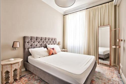 une chambre avec un grand lit et un miroir dans l'établissement Very nice 2p with all comfort, city center Ac/wifi, à Nice